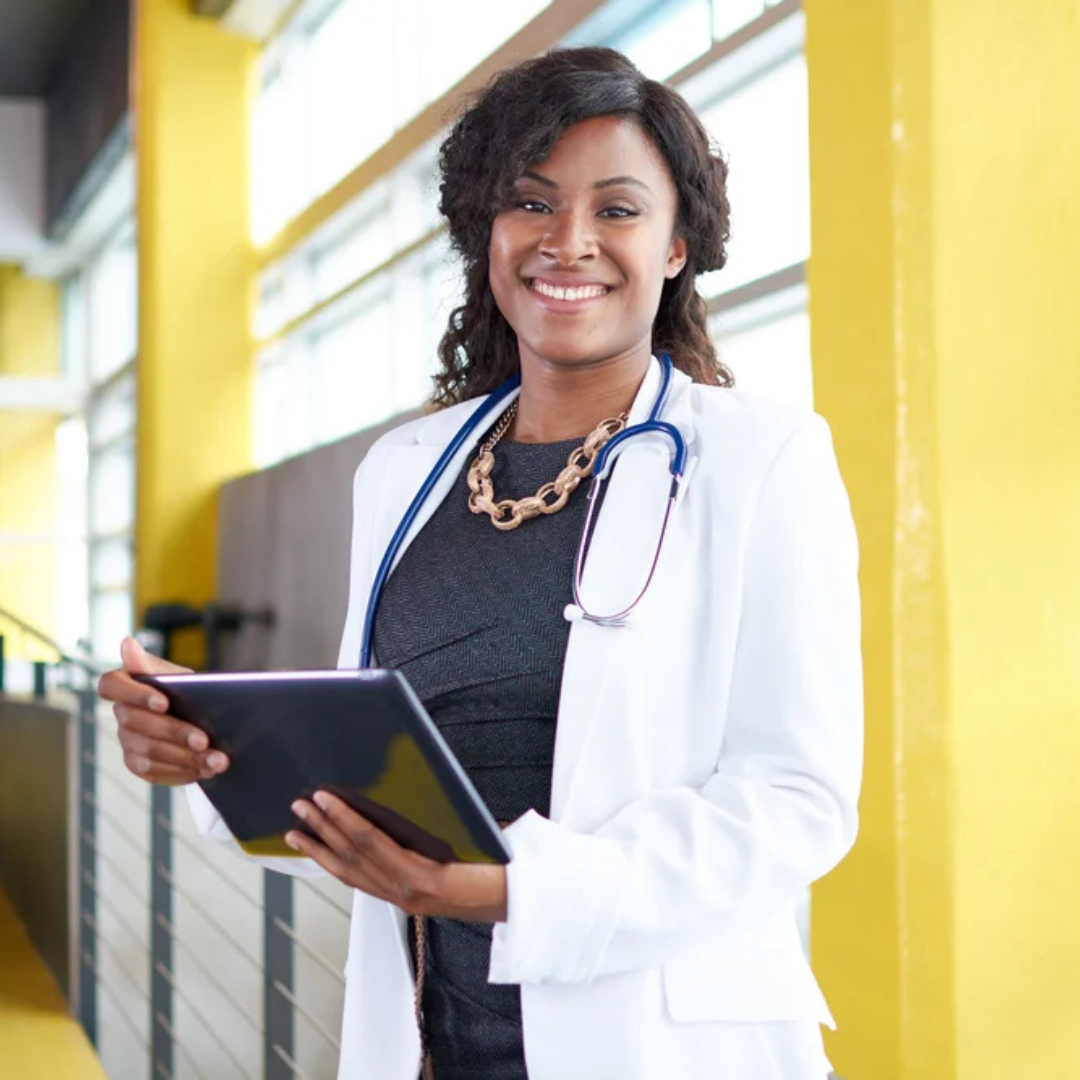 a woman doctor holding a tablet and smiling