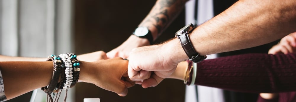 men putting their fists together