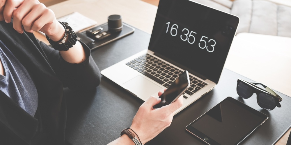 man-checking-his-iphone-working-at-home-office-picjumbo-com-281392-edited