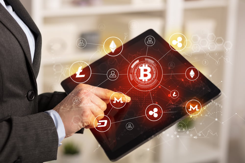 Businessman using tablet with cryptocurrency bitcoin link network concept