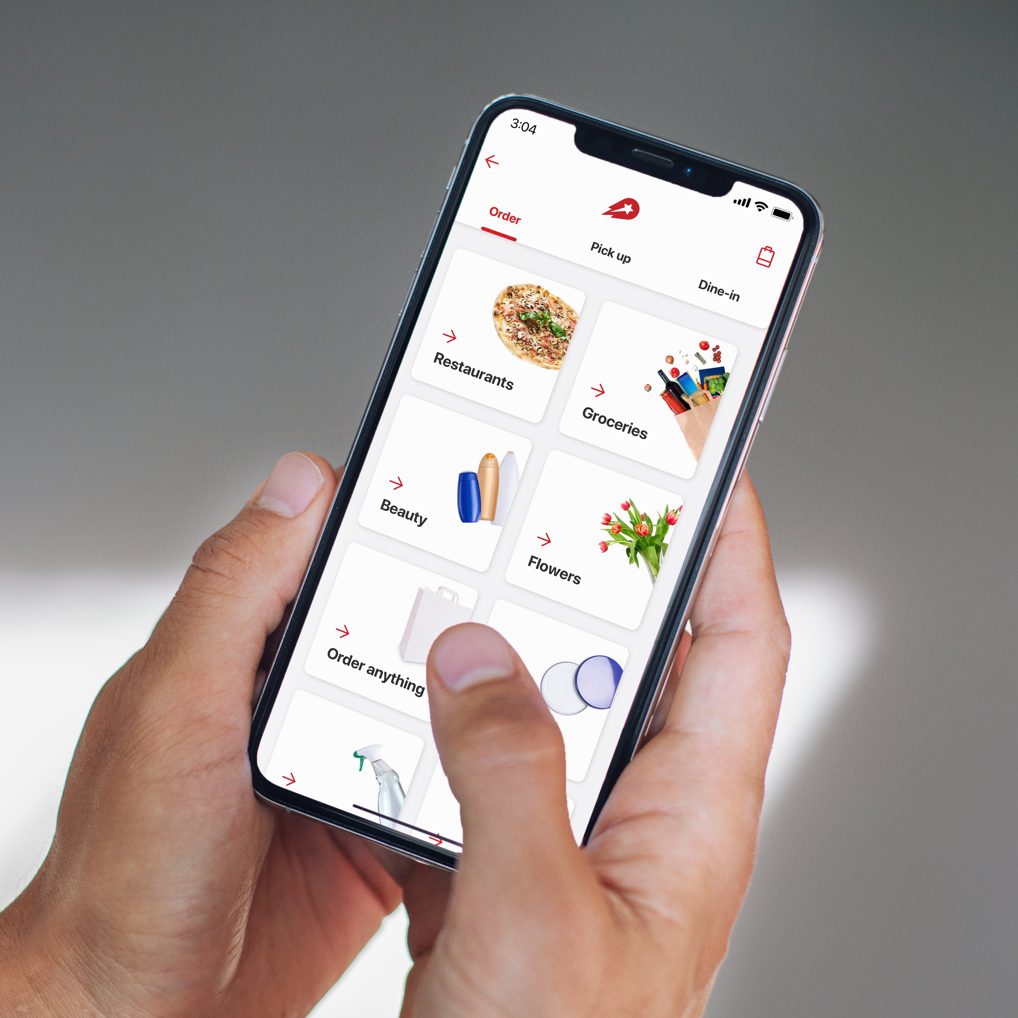 Hands holding a smartphone with a grocery app on.