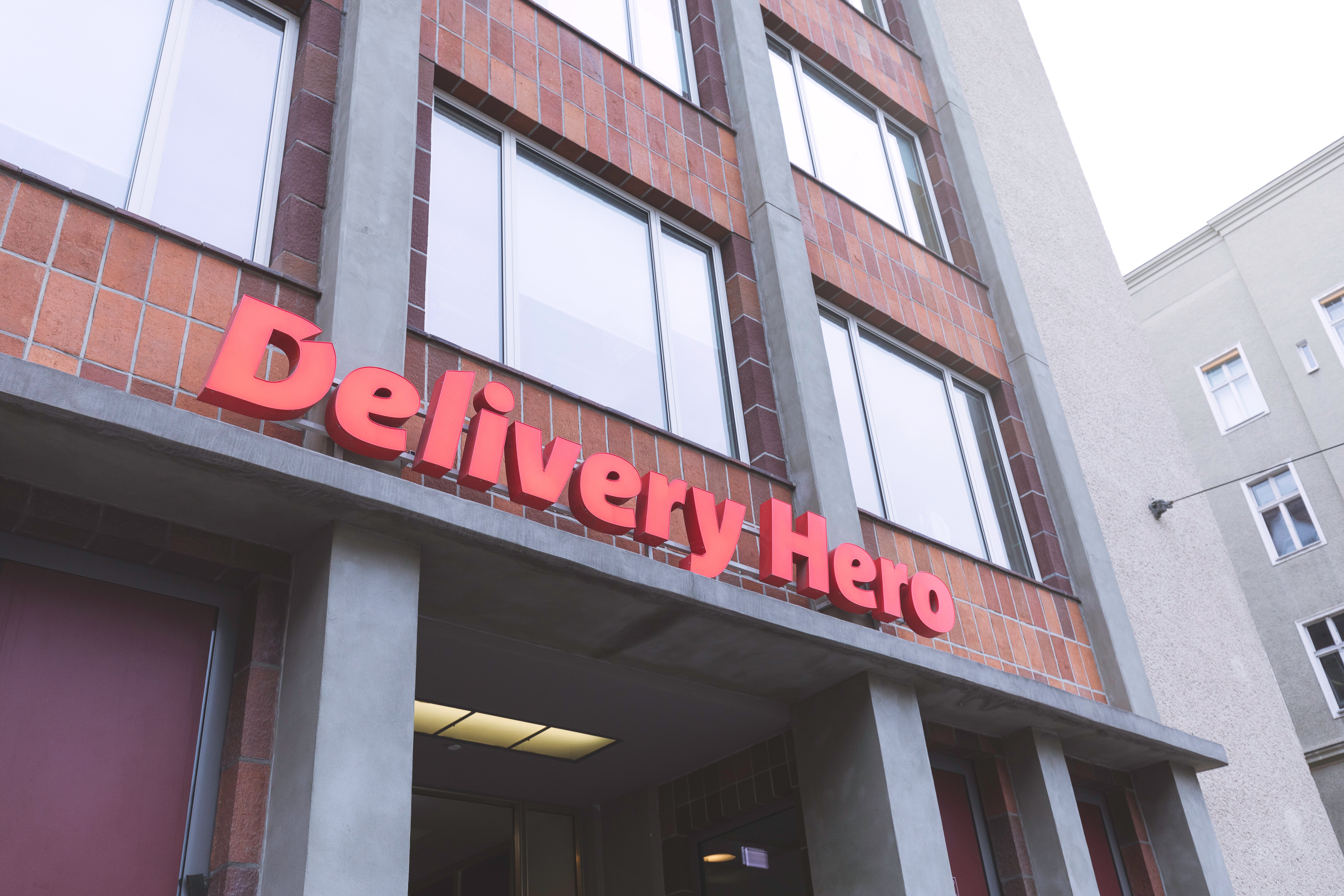 Delivery Hero logo on a wall.