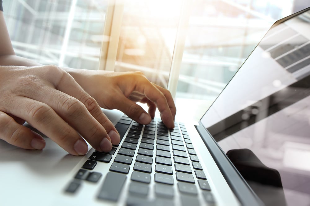 Double exposure of business man hand working on blank screen laptop computer