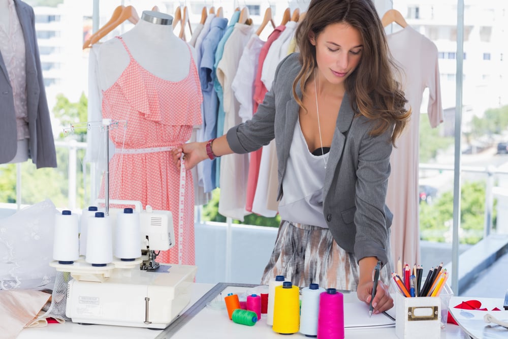 Fashion designer drawing and measuring a mannequin-1