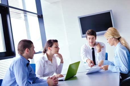 Group of happy young business people in a meeting at office