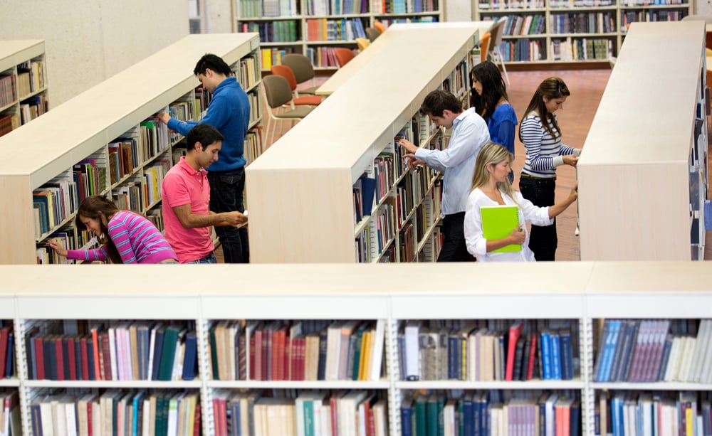 Group of students at the library looking for books