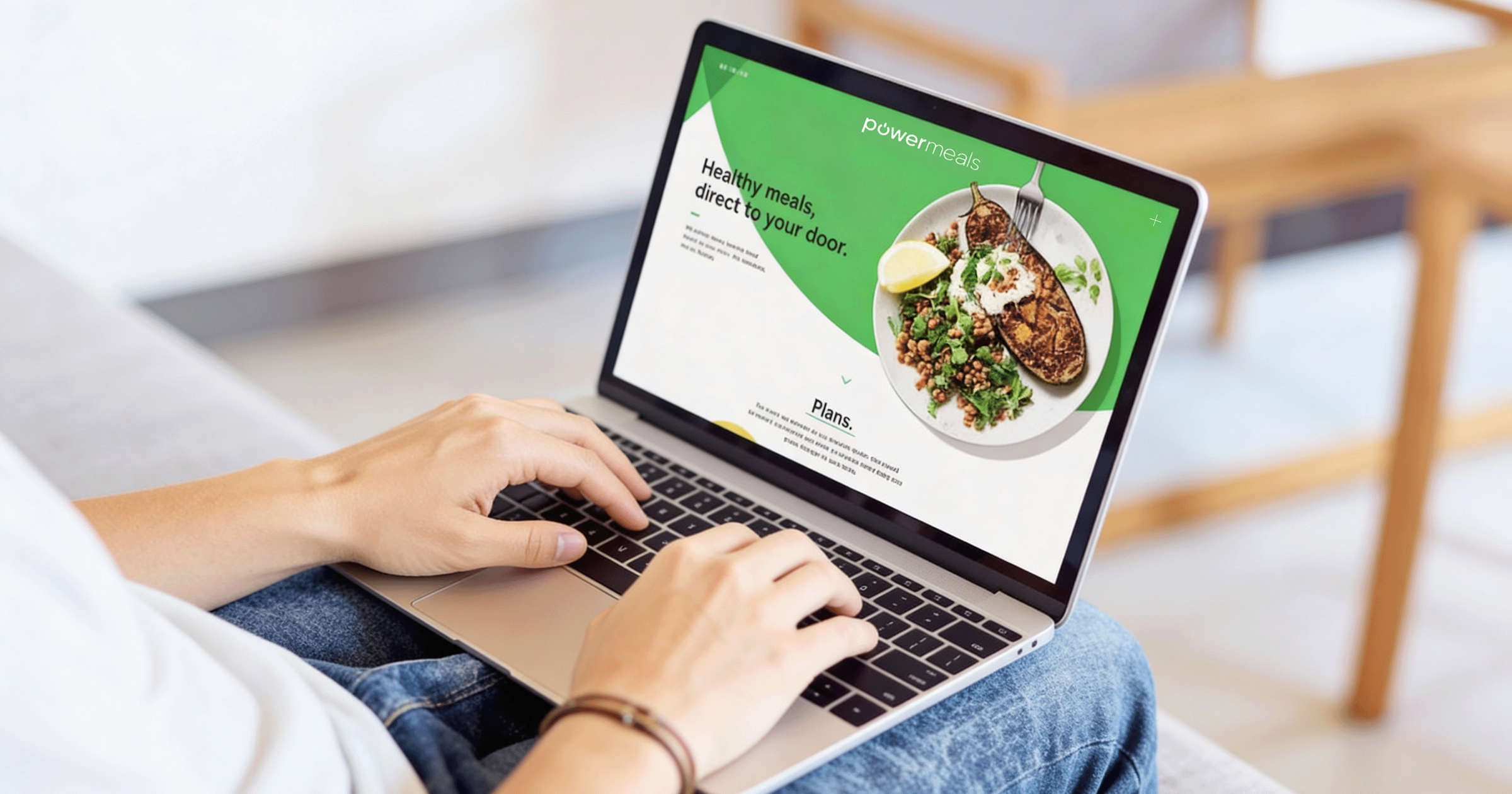 Powemeals website on a laptop.