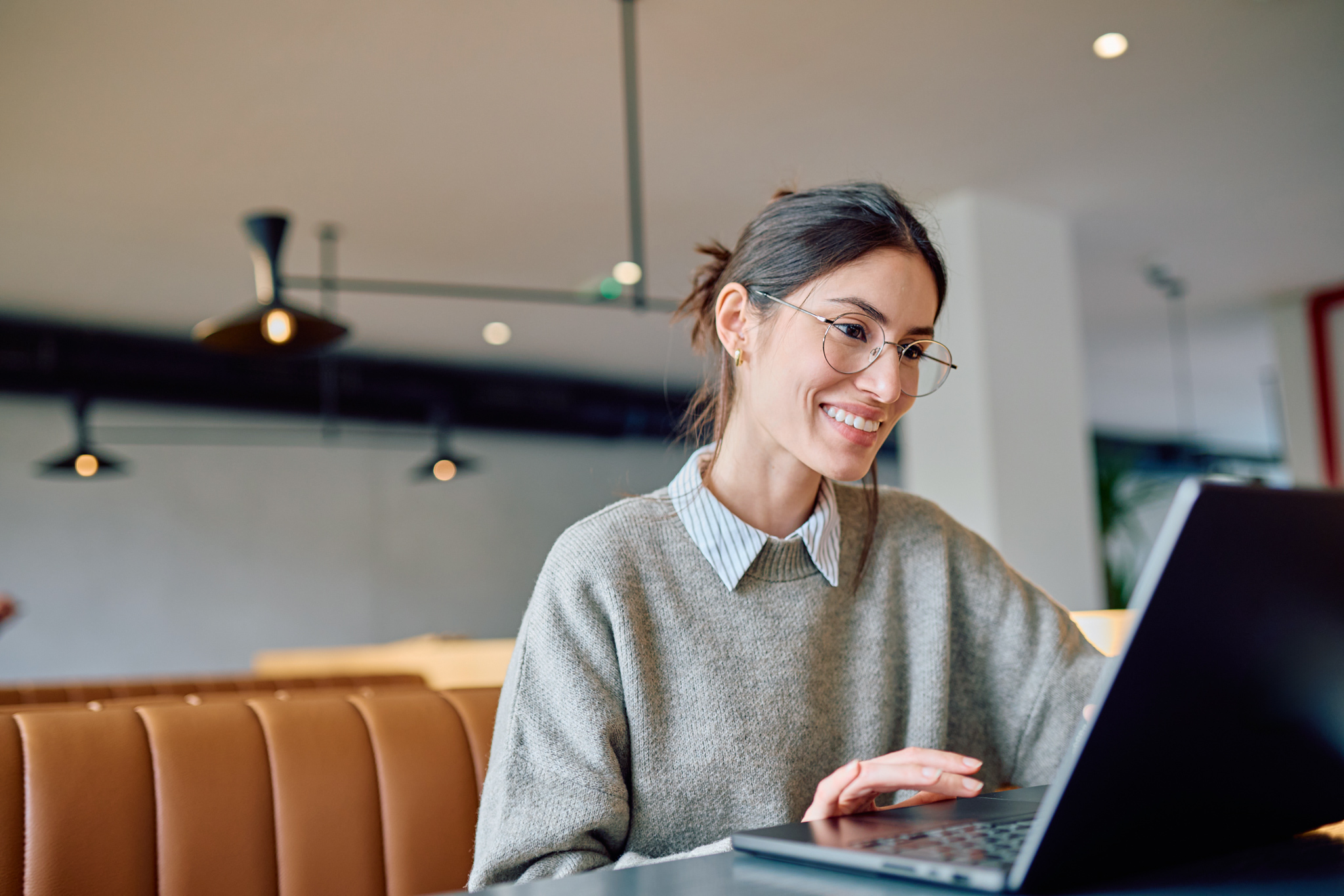 Woman sitting by a laptop.