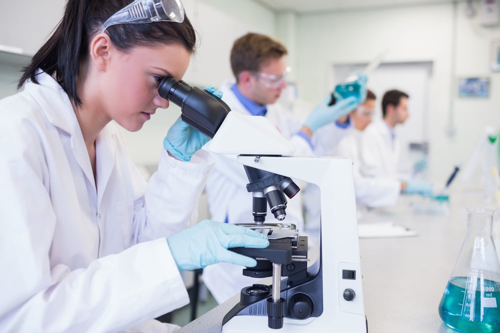 Side view of busy group of researchers working on experiments in the laboratory-1