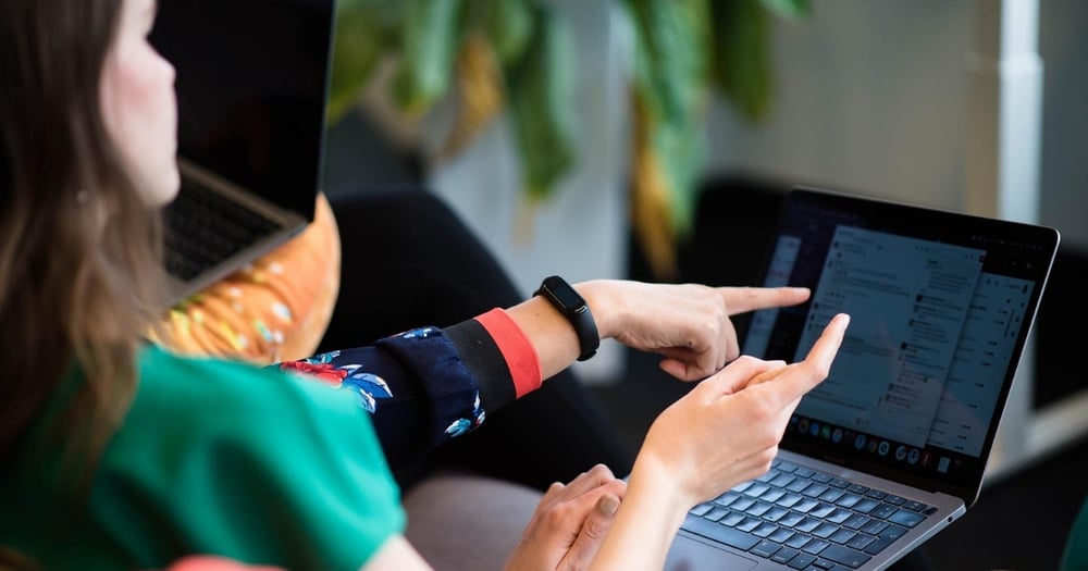 woman pointing out to a computer