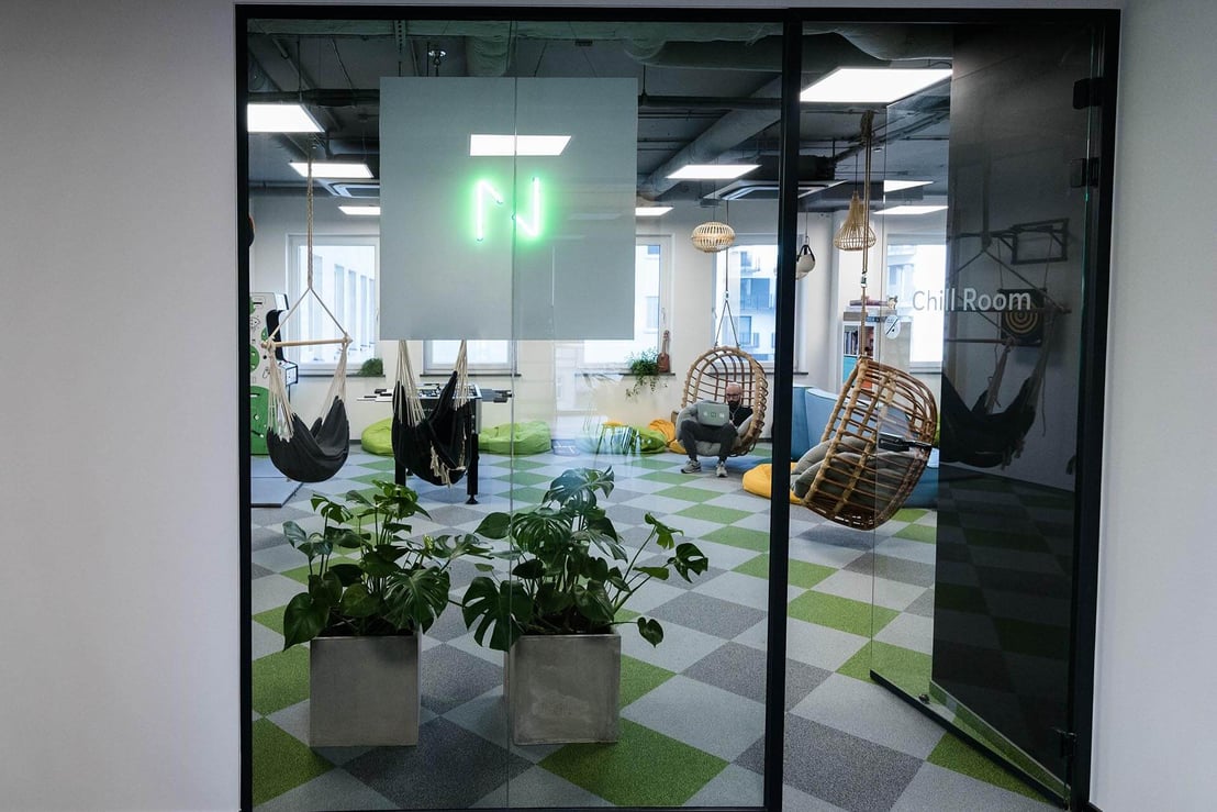 employees sitting in an office made of glass