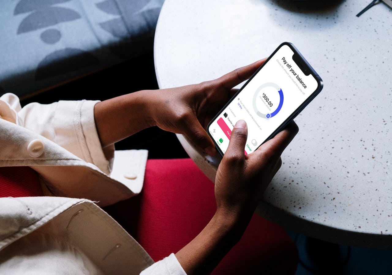 A woman is holding the phone with turned on mobile fintech app