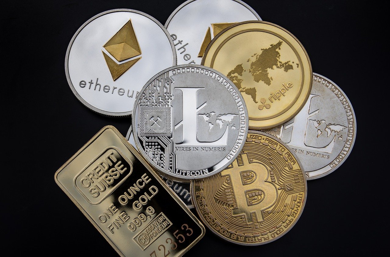 gold ounce with bitcoin, ethereum, litecoin coins on black background
