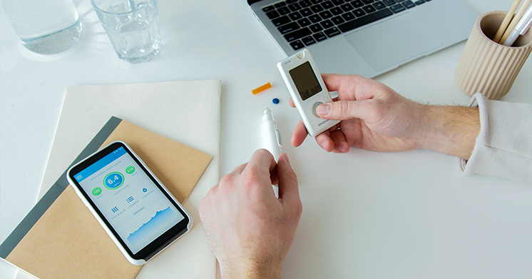 A person with smart devices monitoring health.