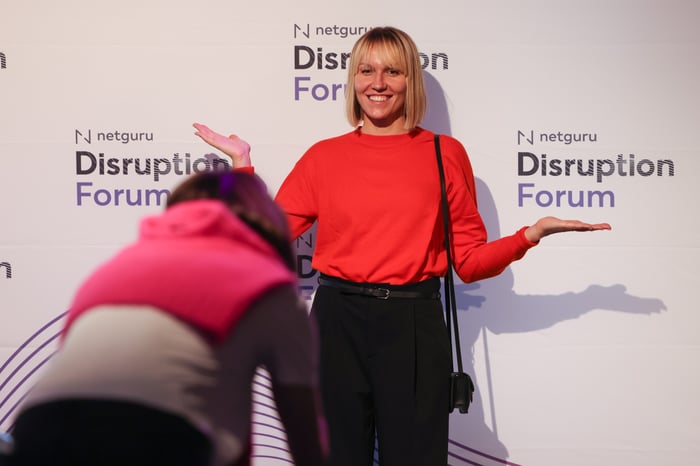 woman standing against a branded background