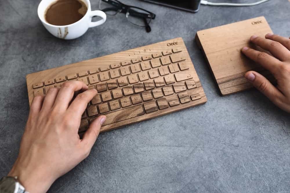 Man working with wooden keyboard
