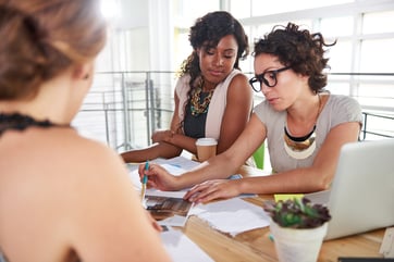 team of successful business people having a meeting in executive sunlit office